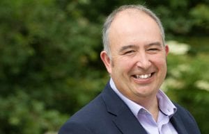 Phil Higginson Director & Independent Financial Adviser standing and smiling outside his office in Rural Somerset